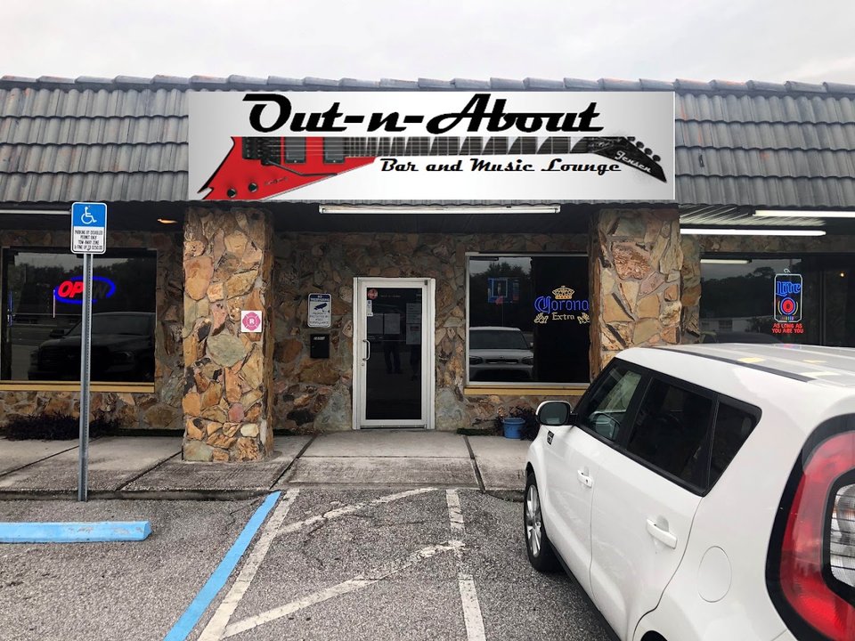 Bar and grill entrance with neon lighting.